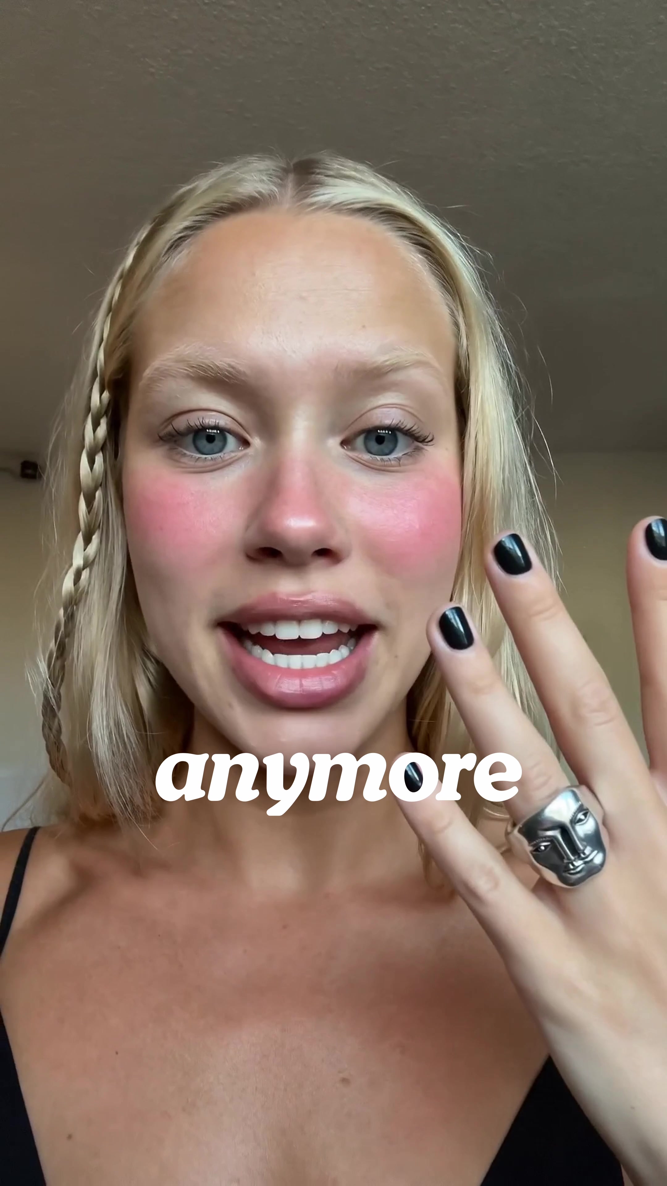 TikTok cover still of Ohneis652 speaking to camera, holding up a product against a plain background, mid-sentence